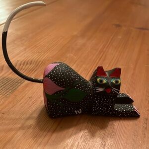 Carved black cat with white tipped tail